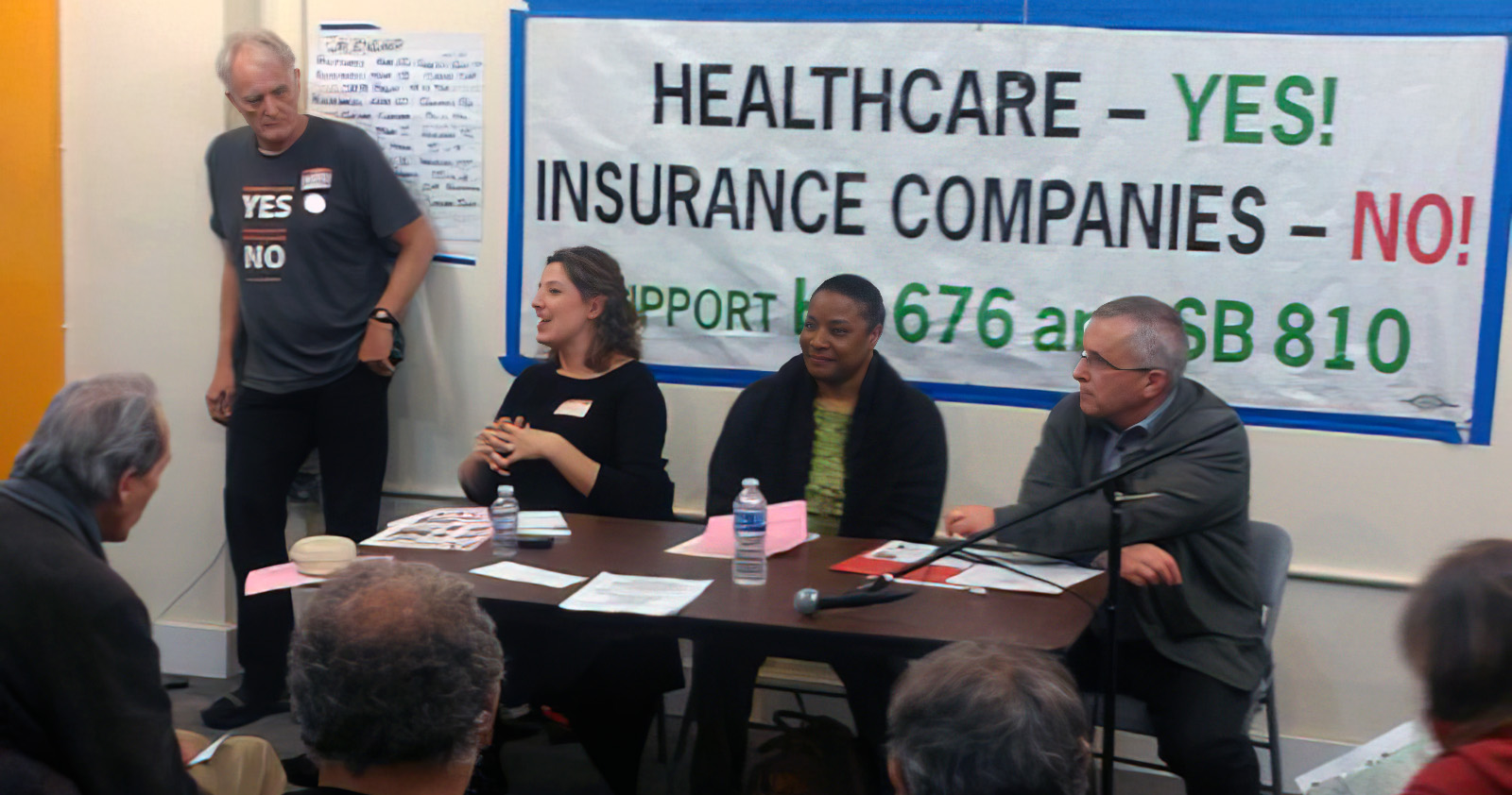 Panel answering questions about single payer legislation at an event
