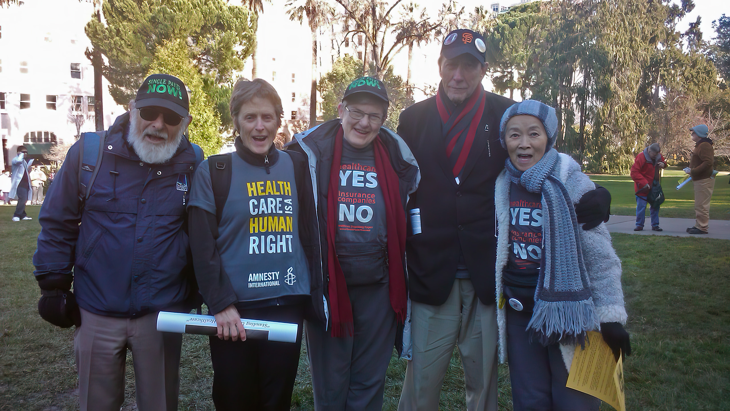 Five organizers wearing SPN T-shirts and hats.